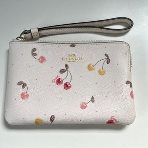 Brand new Coach cherry wristlet.